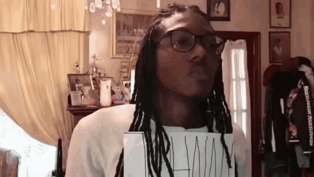 a man wearing glasses is holding a piece of paper that says mr man