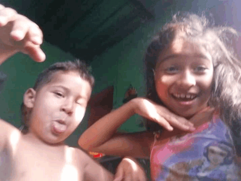 a boy and a girl are posing for a picture and the girl is wearing a disney shirt