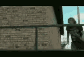 a blurry picture of a woman standing in front of a brick wall