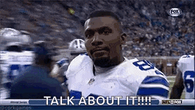 a football player is standing on a field and talking to someone .