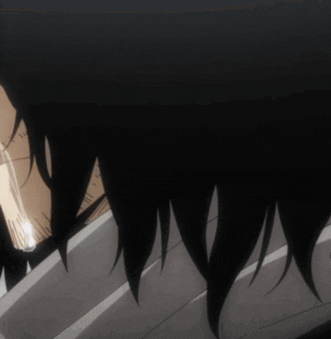 a close up of a person 's face with a beard and long black hair