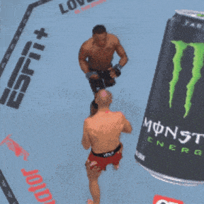 a can of monster energy is next to a fighter on the ground