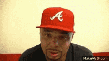 a man wearing a red hat with the letter a on it
