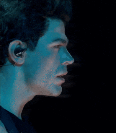 a close up of a man 's face wearing a pair of sony ear buds