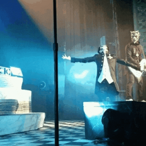a man in a mask is playing a guitar on a stage in front of a sign that says ' ck '