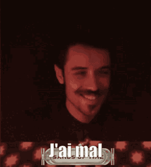 a man is smiling in front of a sign that says j'ai-mal