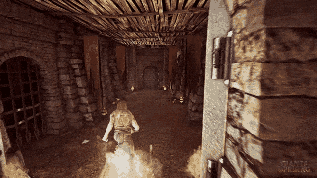 a video game called giants rising shows a man running through a hallway