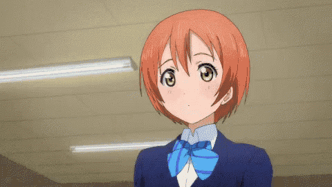a girl with red hair and green eyes is wearing a blue and white bow tie