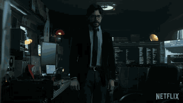 a man in a suit and tie is standing in a dark room with netflix written on the bottom