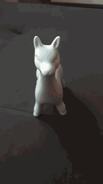 a person is holding a white rabbit on their lap