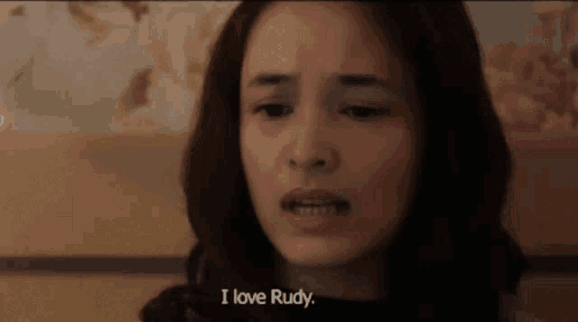 a close up of a woman 's face with the words `` i love rudy '' written on the bottom .