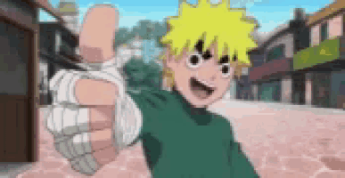a boy in a green shirt is giving a thumbs up sign