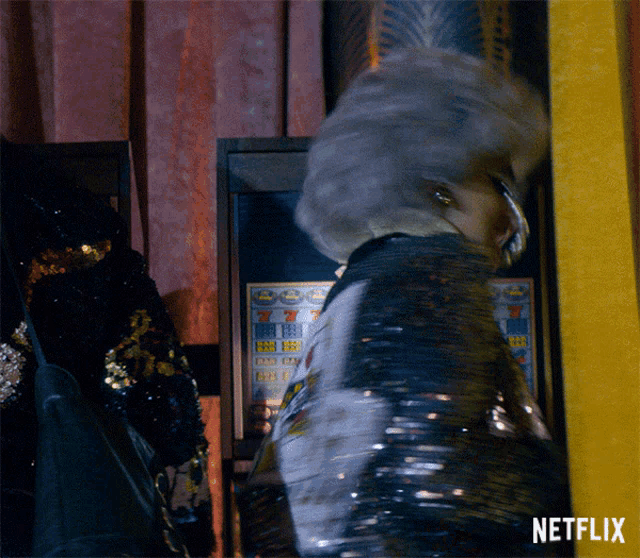 an advertisement for netflix shows a woman in a sequined jacket standing in front of a slot machine