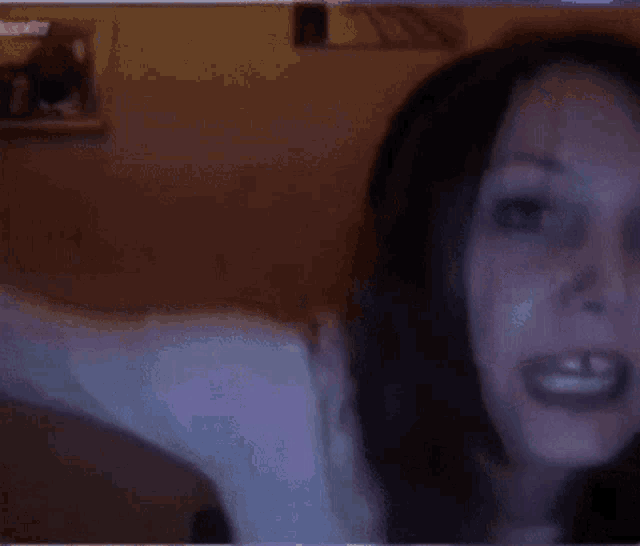 a blurry picture of a woman 's face with a blue background