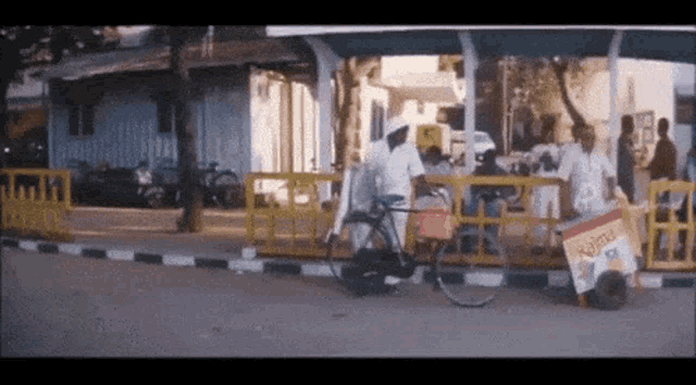 a bicycle is parked on the side of the road in front of a sign that says ' kumar ' on it