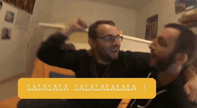 two men are sitting on a couch and one of them says " lalala lalala lalala "