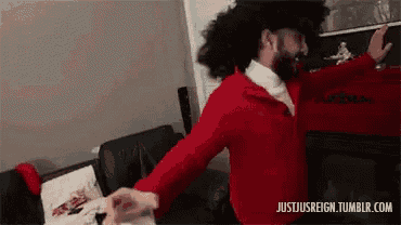 a man in a red jacket and a pirate hat is dancing in a living room .