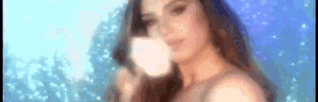 a blurry picture of a woman drinking from a cup .