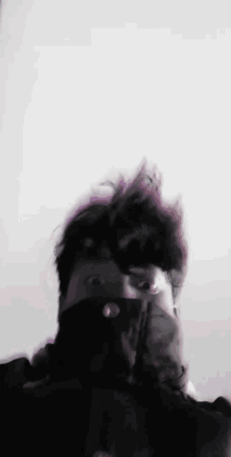 a close up of a person wearing a black mask on their face .