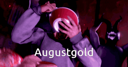 a poster for augustgold shows a person covering their face with a red object
