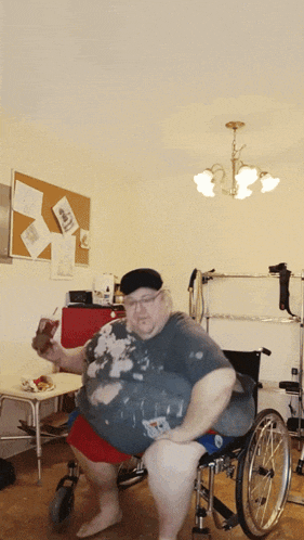 a man in a wheelchair is holding a bottle of soda