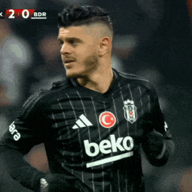 a soccer player wearing a beko jersey is running