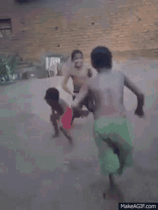 a group of young boys are playing soccer in the mud