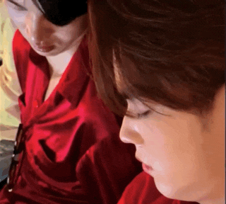 a man and a woman in red shirts are looking down