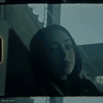 a close up of a woman 's face behind a glass