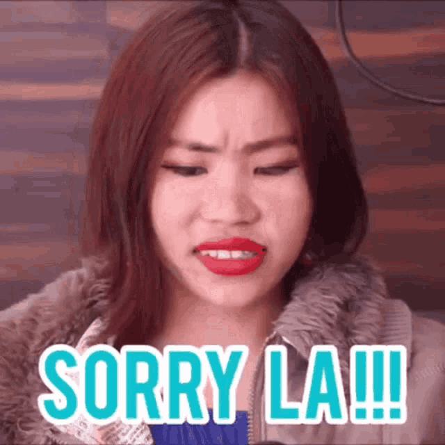 a woman is making a face and saying sorry la !!