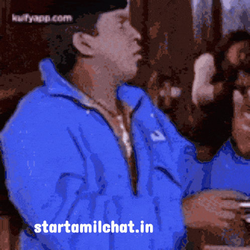 a man wearing a blue jacket with the website starttamilchat.in on the bottom