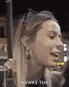 a close up of a woman 's face with a caption that says hawks tua .
