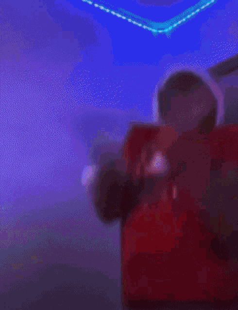 a man in a red shirt with the number 10 on it is dancing