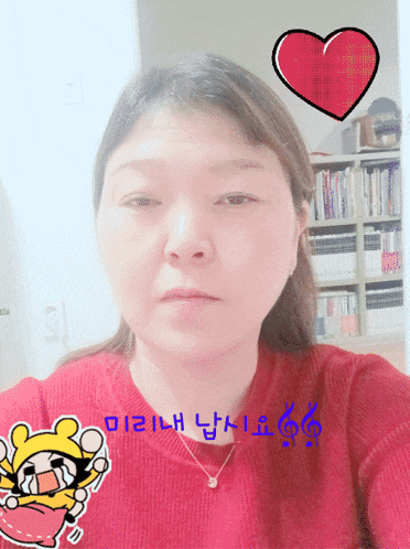 a woman wearing a red sweater has a sticker on her face that says i love you