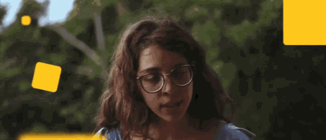 a woman wearing glasses is looking down at something
