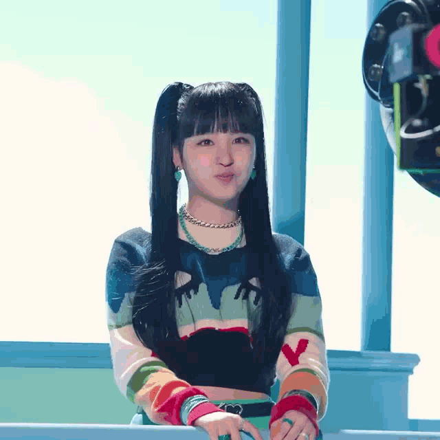 a woman wearing a colorful sweater with the letter y on the front