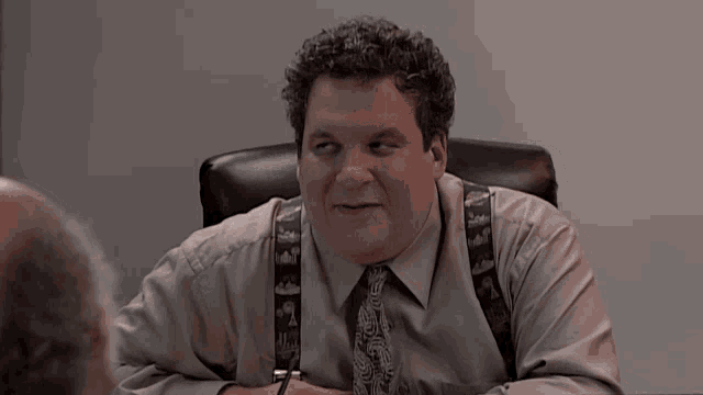 a man sitting at a desk with the words hey i 'm pro vagina