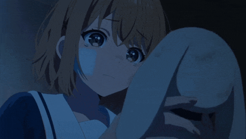 a girl with her eyes closed holds a stuffed animal
