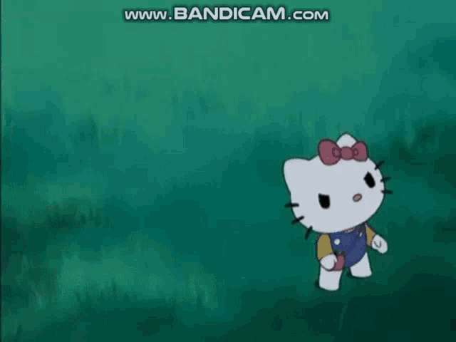 a girl and a hello kitty are standing next to each other in the grass .