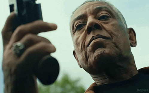 a close up of a man holding a camera with the word kepler in the corner