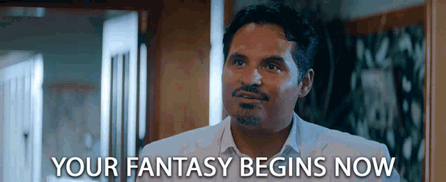 a man in a white suit says " your fantasy begins now " in front of him