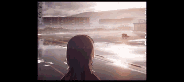 a girl is standing on a street looking at the sun