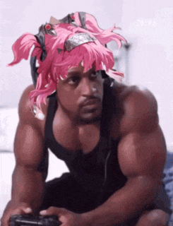 a man with pink hair is playing a video game .