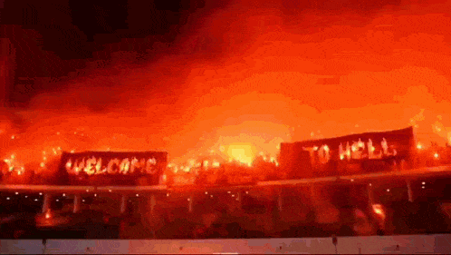 a sign that says " welcome to hell " is surrounded by flames