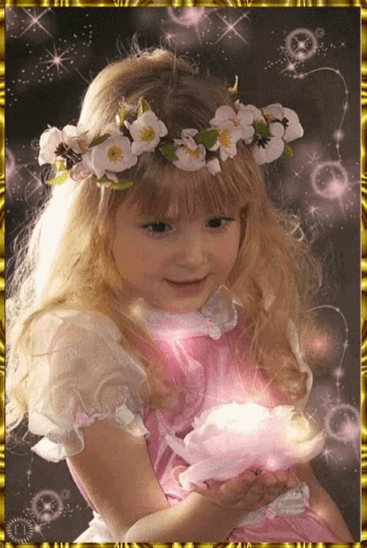 a little girl with a flower crown on her head is holding a pink flower