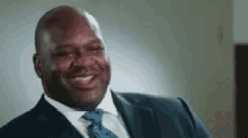 a man in a suit and tie is smiling for the camera .