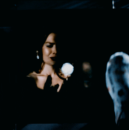 a woman singing into a microphone on a screen that says ' i love you '