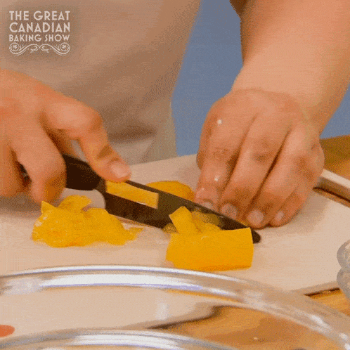 a person is cutting a yellow pepper on a cutting board with the words the great canadian baking show on the bottom