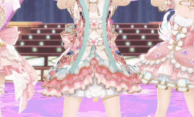 a girl in a pink dress is standing on a stage with other girls