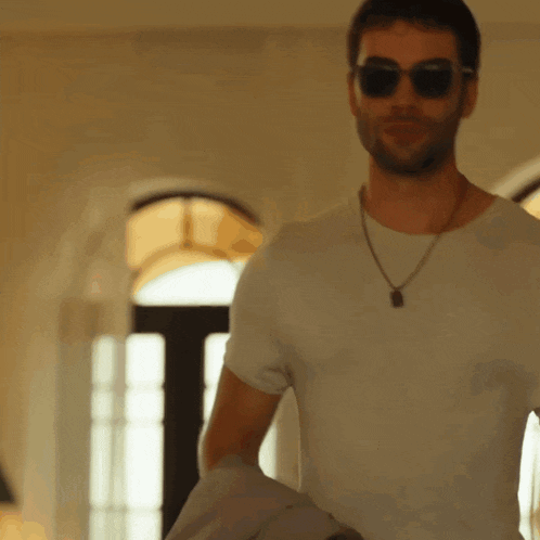 a man wearing sunglasses and a white t-shirt